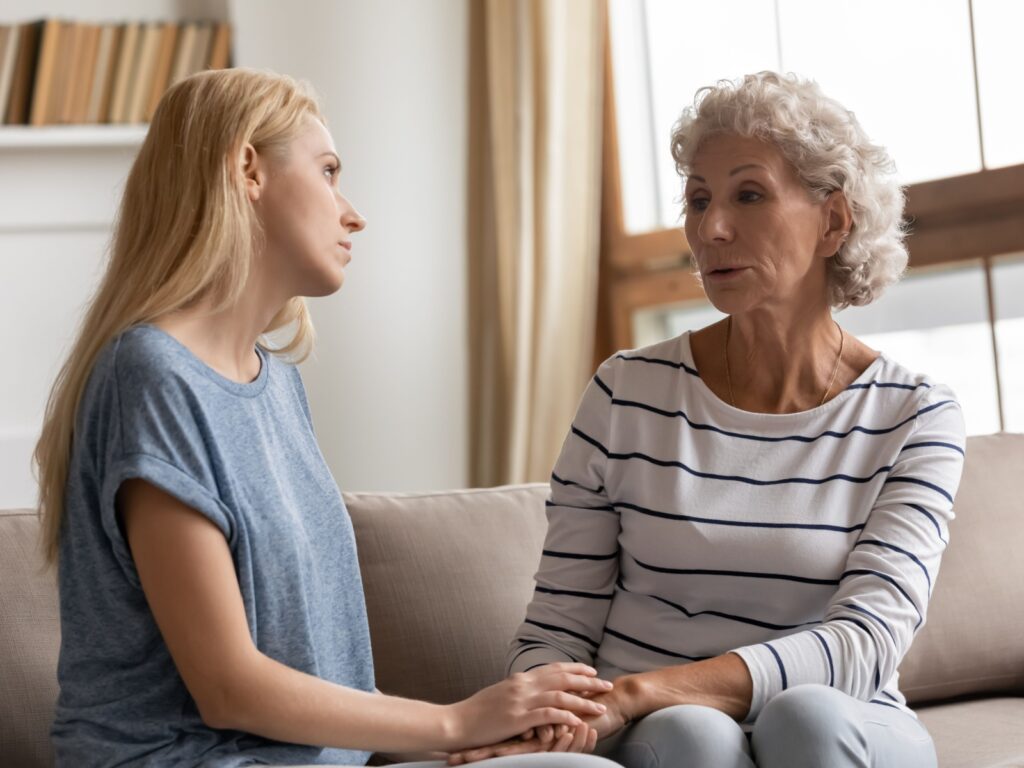 A mother and adult daughter talking.