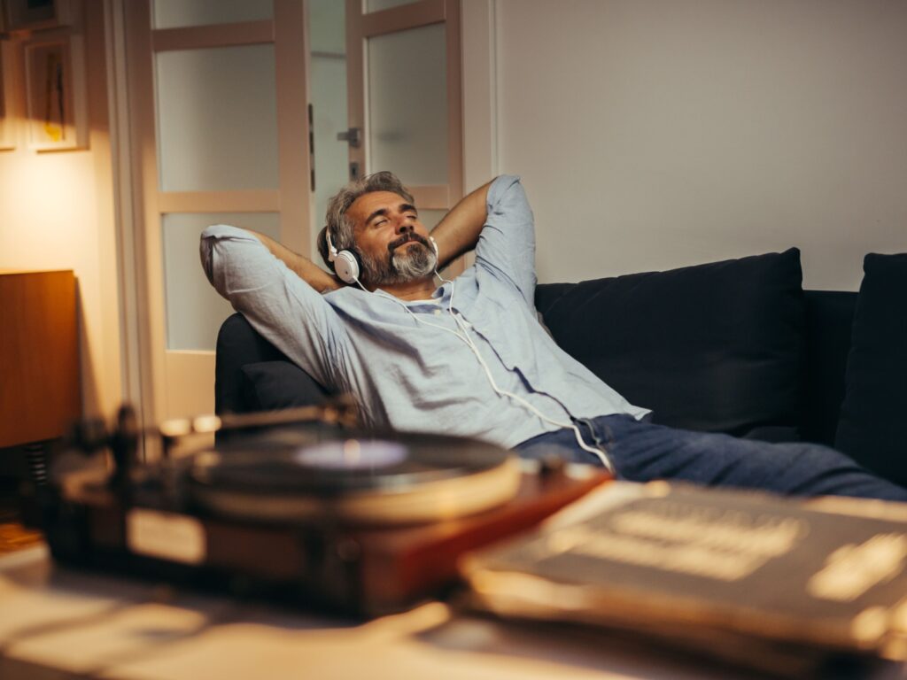 A man relaxing while listening to music.