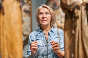 A woman looking at art in a gallery.