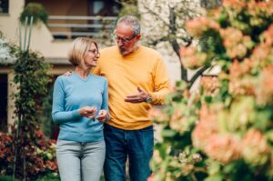 Mature couple walking outside a house